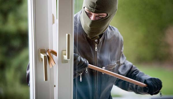 Robber Breaking in Glass Door of House